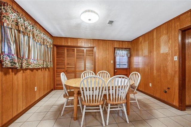 tiled dining area with wooden walls