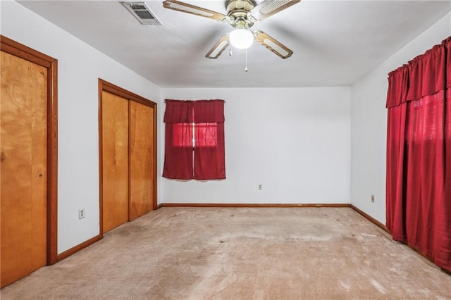 unfurnished bedroom with ceiling fan and light carpet