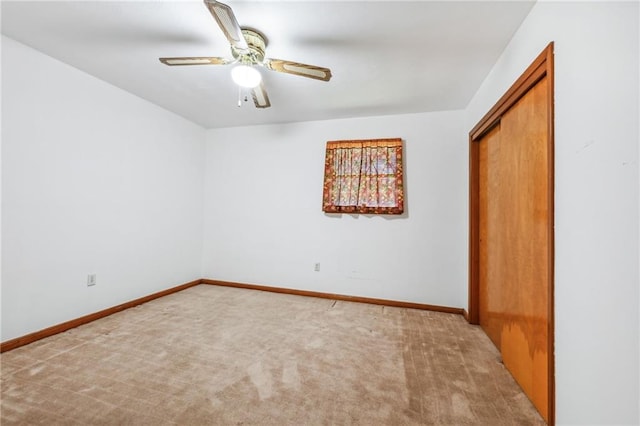 spare room with carpet flooring and ceiling fan