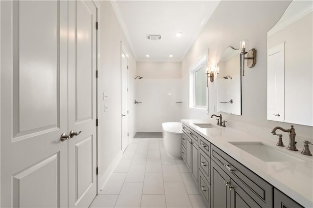 bathroom with vanity, tile patterned floors, and a washtub