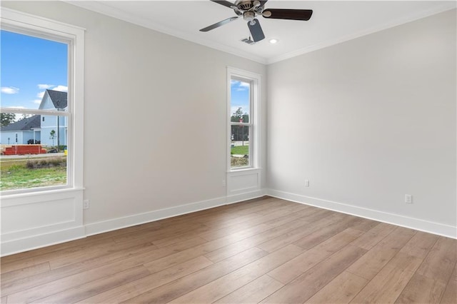 empty room with crown molding, light hardwood / wood-style flooring, and ceiling fan