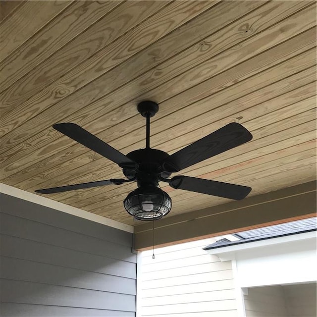 details with wooden walls, wood ceiling, and ceiling fan