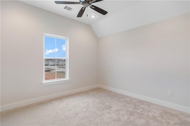 carpeted empty room featuring vaulted ceiling and ceiling fan