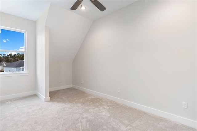 bonus room featuring light carpet, lofted ceiling, and ceiling fan