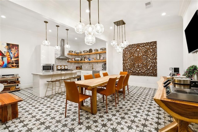 1900 N Rampart St, New Orleans, LA 70116 - dining room featuring light flooring, recessed lighting, ornamental molding, and a chandelier