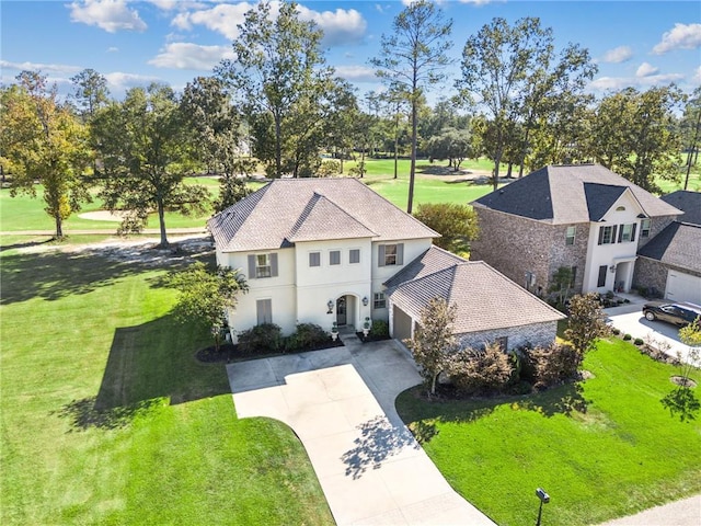 view of front of property with a front lawn and a garage