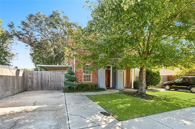 obstructed view of property featuring a front lawn