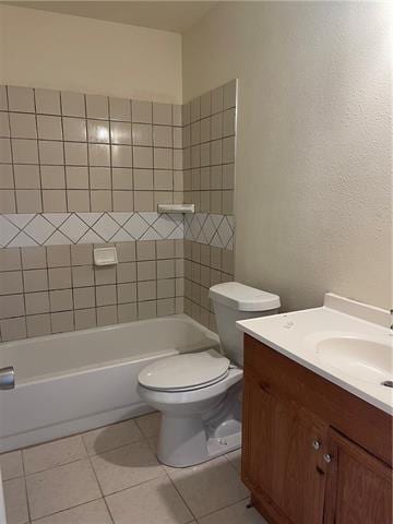 bathroom with toilet, shower / bath combination, vanity, and tile patterned floors