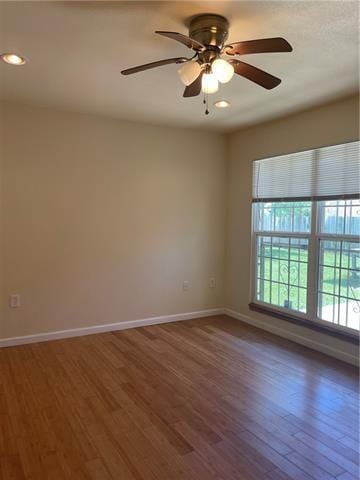 spare room featuring ceiling fan, baseboards, wood finished floors, and recessed lighting