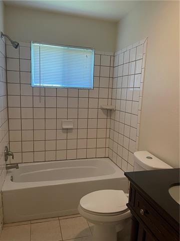 full bathroom featuring toilet,  shower combination, vanity, and tile patterned floors