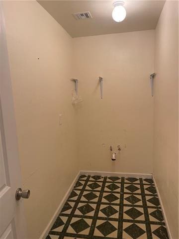 laundry area with visible vents and baseboards