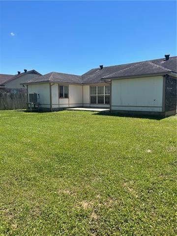 back of house with a lawn