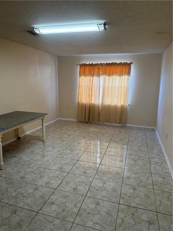 spare room with a textured ceiling