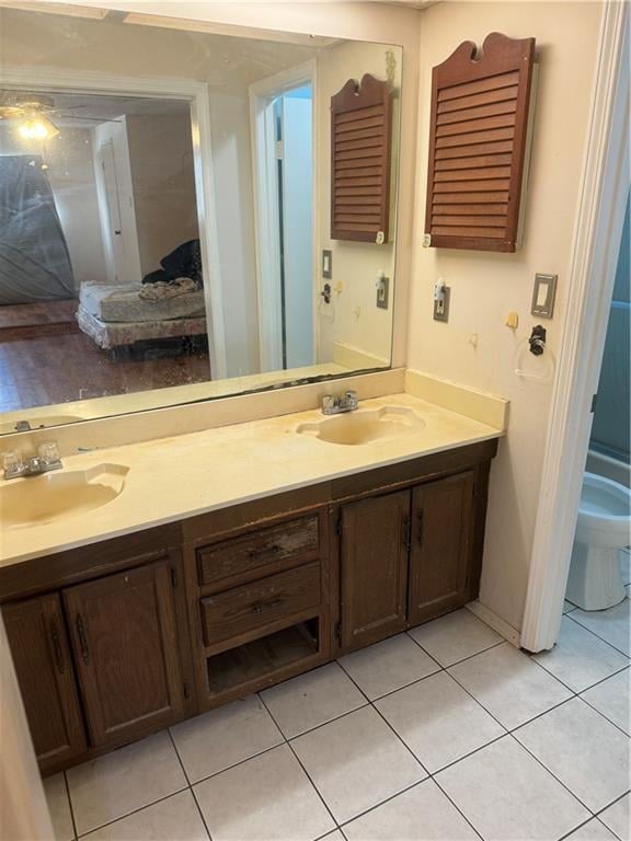 bathroom featuring vanity, toilet, and tile patterned flooring