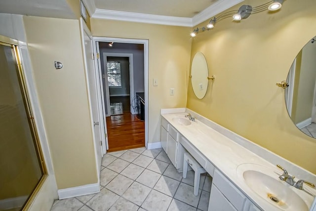 bathroom featuring vanity, crown molding, a shower with shower door, and tile patterned flooring