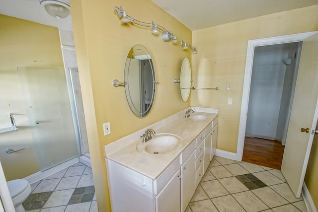 bathroom featuring vanity, toilet, and tile patterned flooring