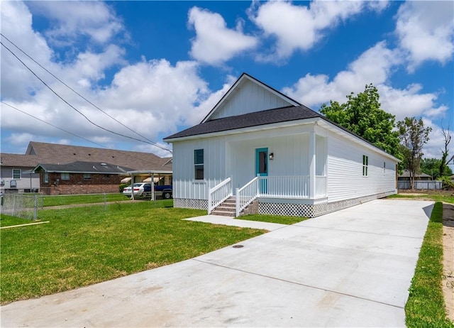 5144 Richland Ave, Marrero, LA 70072 - view of front of home with driveway, board and batten siding, and a front lawn