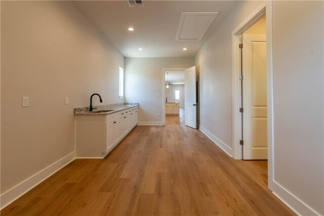 5144 Richland Ave, Marrero, LA 70072 - hall featuring light wood-type flooring, baseboards, a sink, recessed lighting, and attic access