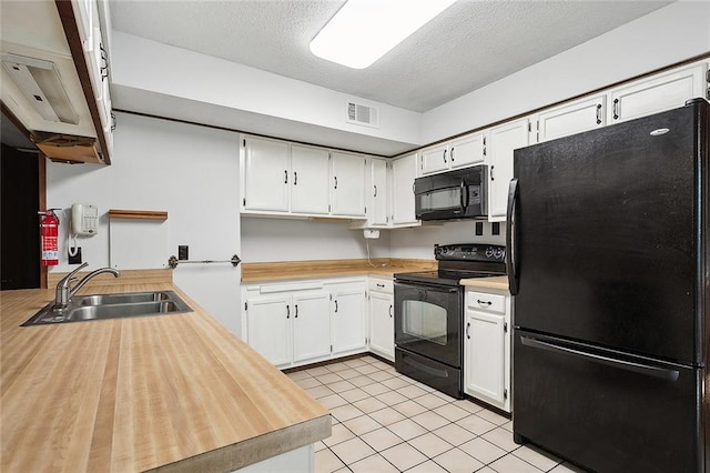 kitchen with black appliances, sink, a textured ceiling, white cabinets, and light tile patterned floors