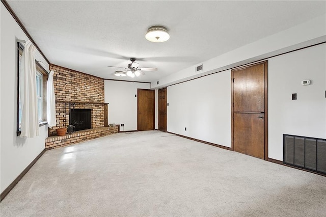 unfurnished living room with ceiling fan, a brick fireplace, and light colored carpet