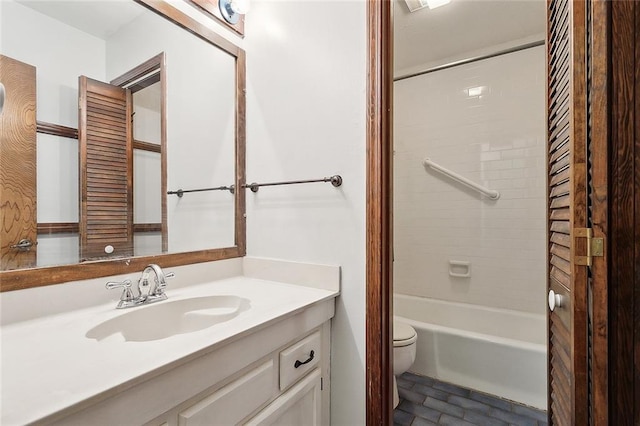 full bathroom featuring toilet, tiled shower / bath combo, and vanity