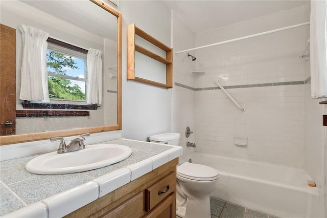 full bathroom featuring toilet, tiled shower / bath, vanity, and tile patterned floors