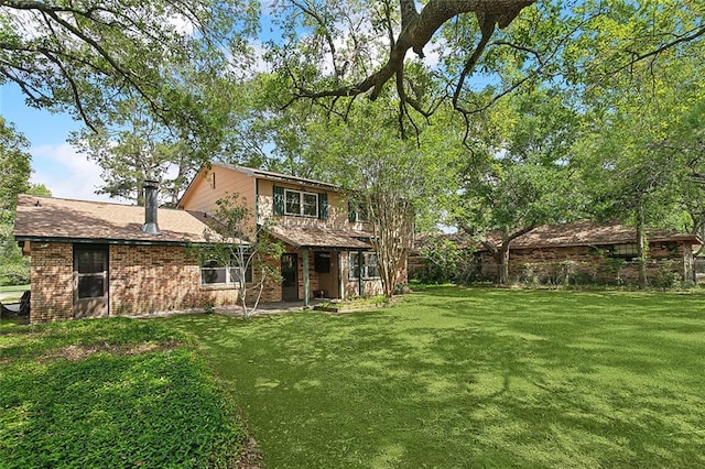 rear view of house with a lawn