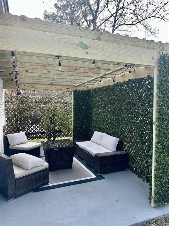 view of patio / terrace with an outdoor living space and a pergola