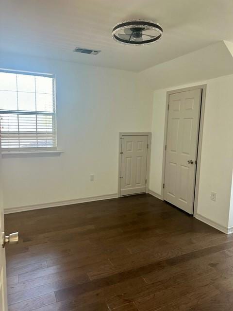 empty room featuring dark hardwood / wood-style flooring