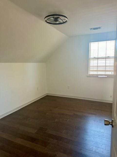 bonus room with lofted ceiling and dark wood-type flooring