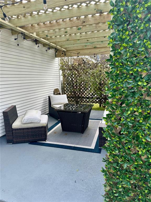 view of patio featuring a pergola and an outdoor living space