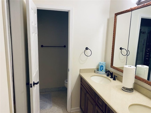 bathroom with vanity, toilet, and tile patterned flooring