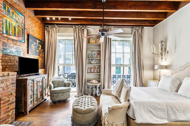 bedroom featuring brick wall, wood-type flooring, and beamed ceiling