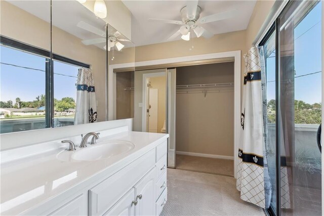 bathroom with a wealth of natural light, vanity, and ceiling fan