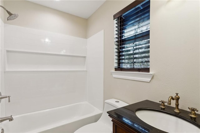 full bathroom with vanity, washtub / shower combination, and toilet