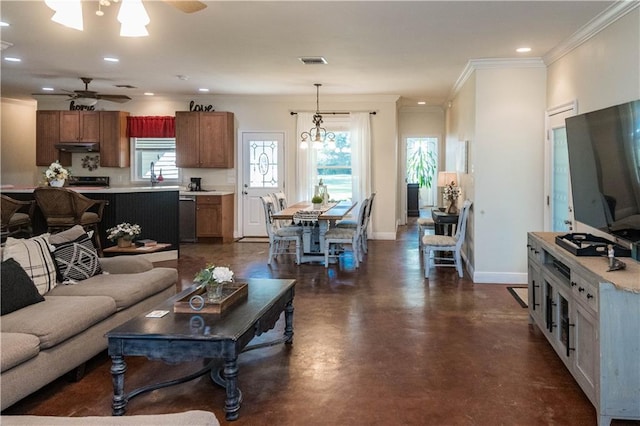 living room featuring ceiling fan with notable chandelier and ornamental molding