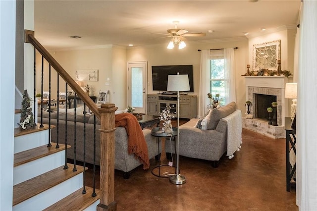 living room with a brick fireplace, ceiling fan, and ornamental molding