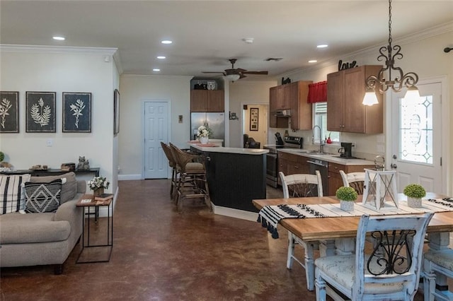 dining room featuring ceiling fan with notable chandelier, ornamental molding, and sink