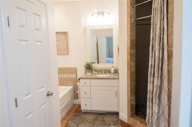 bathroom with tile patterned floors, vanity, and shower with separate bathtub