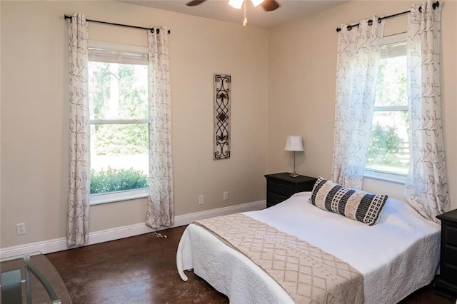 bedroom with ceiling fan and multiple windows