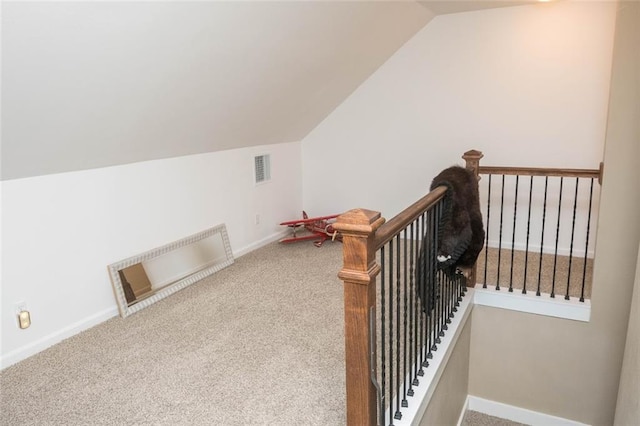 additional living space featuring lofted ceiling and carpet floors