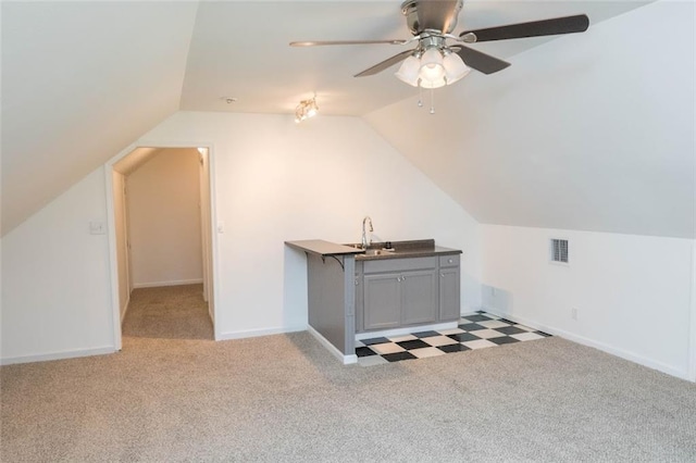 bonus room featuring light carpet, vaulted ceiling, ceiling fan, and sink