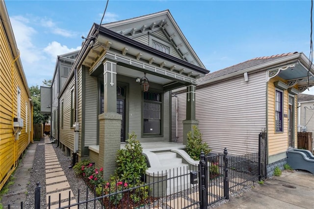 view of front of home featuring a porch and fence