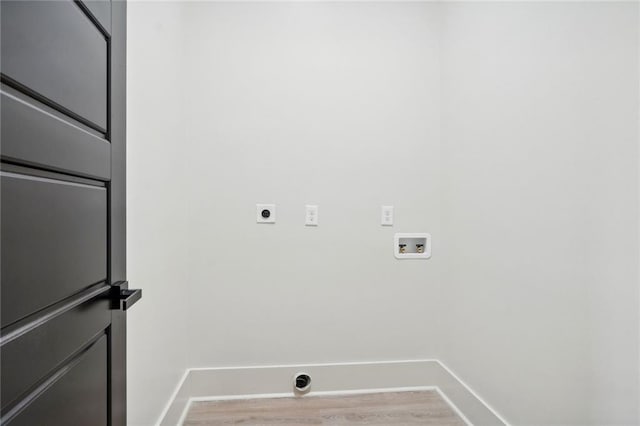 laundry area featuring washer hookup, electric dryer hookup, wood finished floors, laundry area, and baseboards