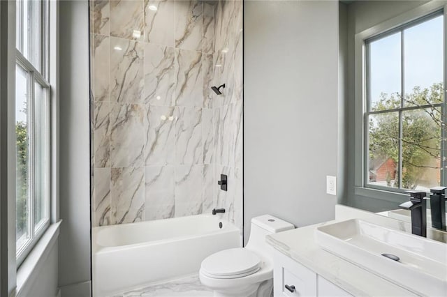 full bathroom featuring toilet, marble finish floor, shower / bath combination, and vanity