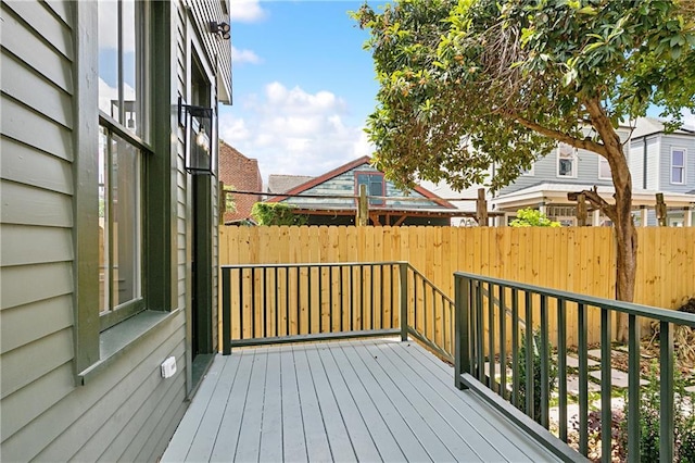 wooden terrace featuring fence