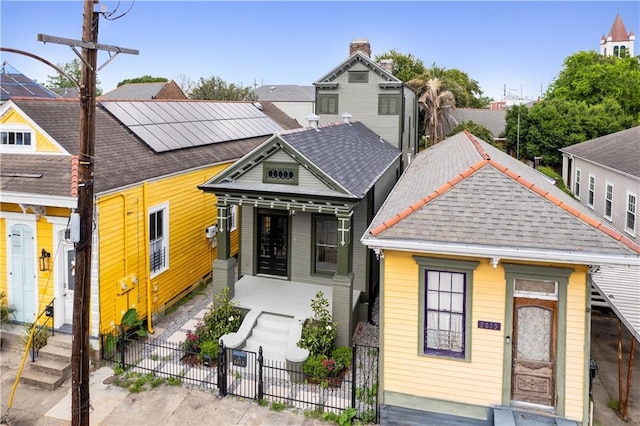 view of front of home featuring roof with shingles and a fenced front yard