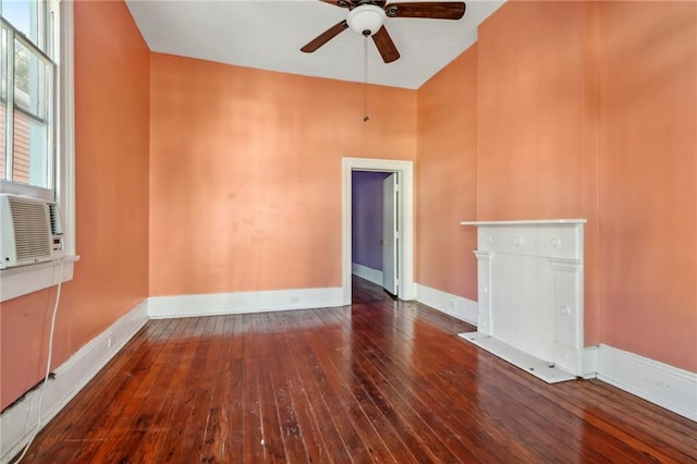 unfurnished living room featuring ceiling fan, a high ceiling, and dark hardwood / wood-style flooring