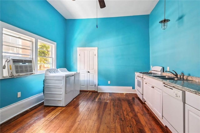 laundry room with sink, cooling unit, dark hardwood / wood-style flooring, ceiling fan, and washer and clothes dryer