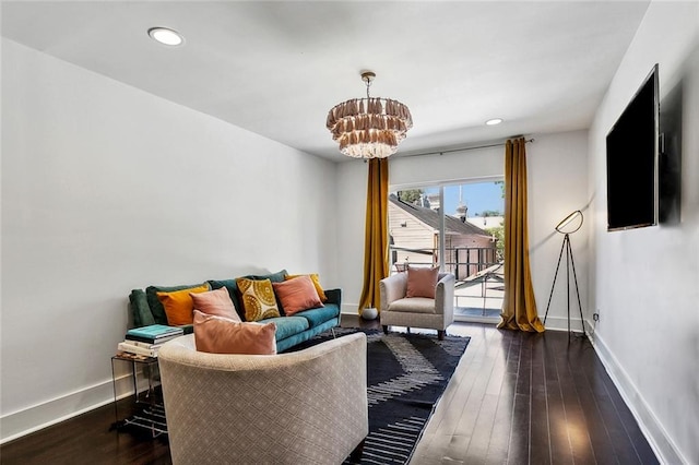 living room featuring a chandelier and dark wood-type flooring